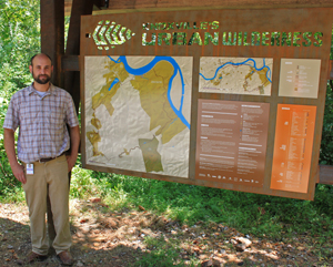 Alex, next to his map in the kiosk